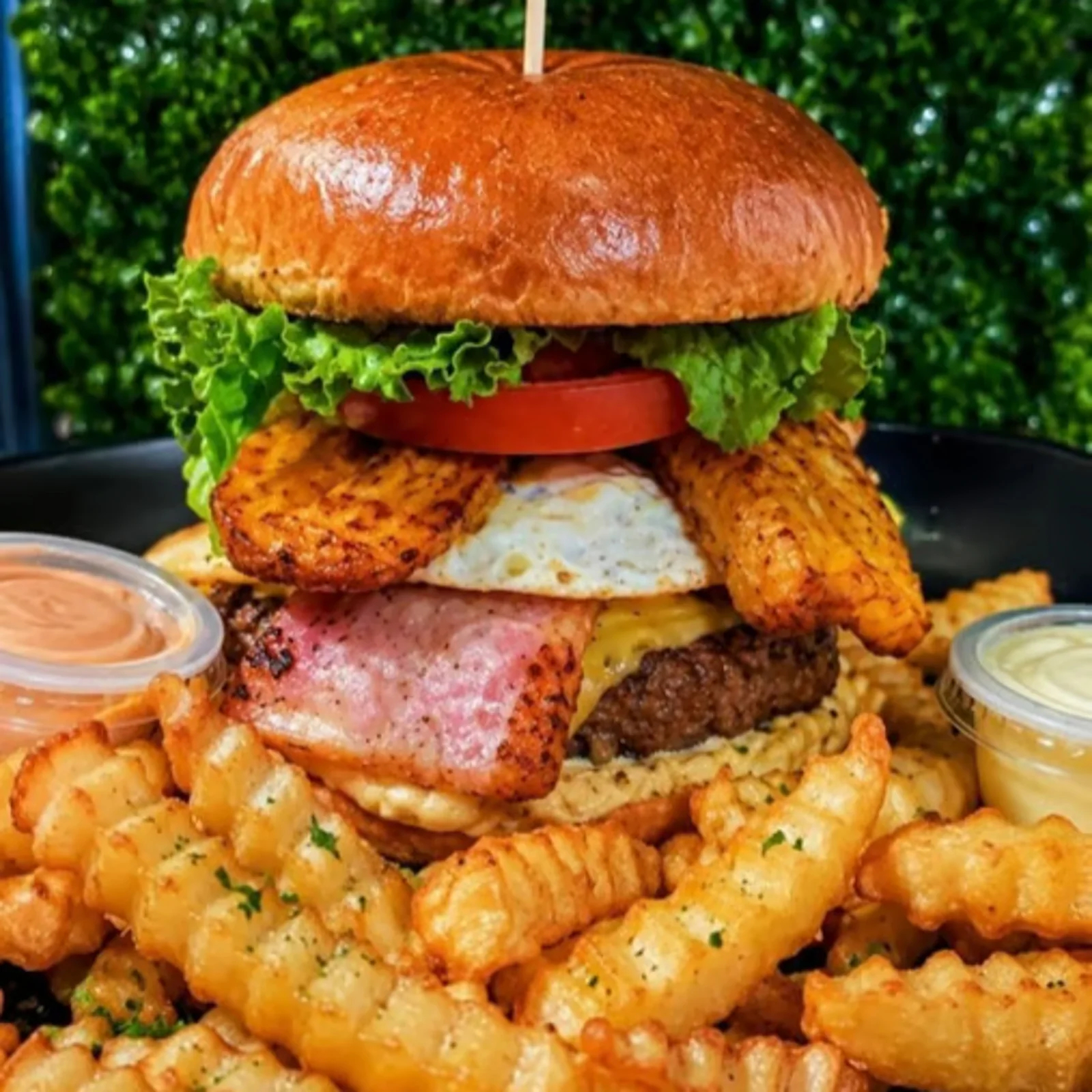 Latina 239 burger stacked with bacon, egg, sweet plantain and crinkle fries